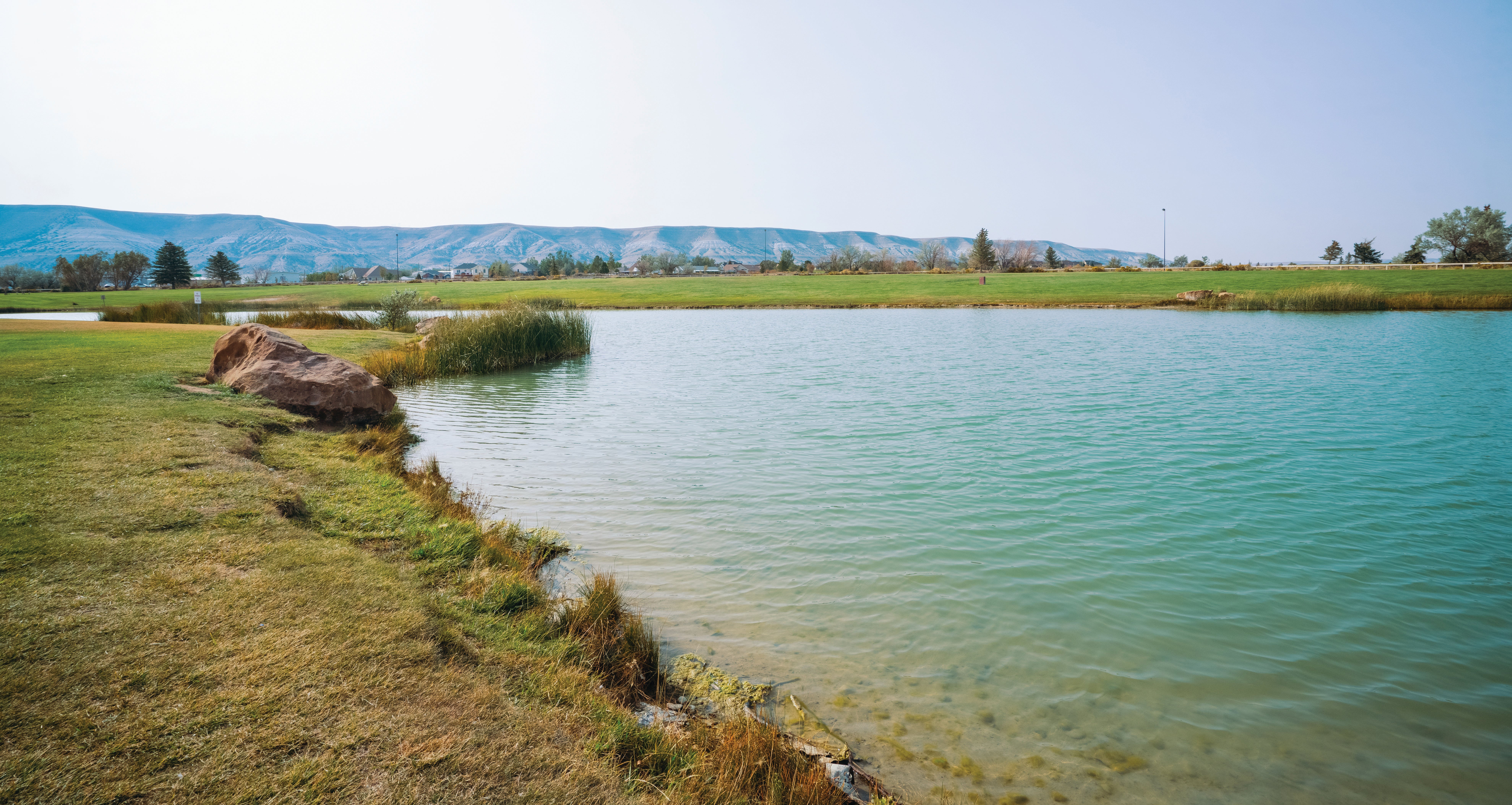 A landscape shot of Rock Springs Pond with White Mountain and blue sky in the background.