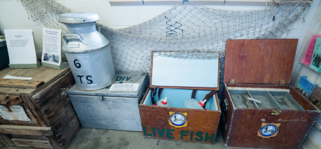 Milk cans and old coolers in the entrance of Daniel Fish Hatchery that show equipment that historically was used at the fish hatchery.