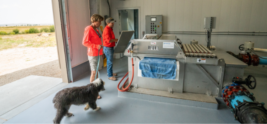 A member of the public gets a fish hatchery tour and learns about fish hatchery water treatment equipment