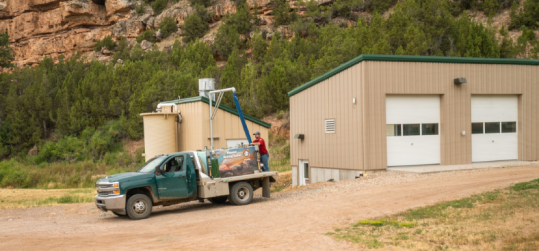 Filling a fish distribution truck with water in preparation to load it with fish